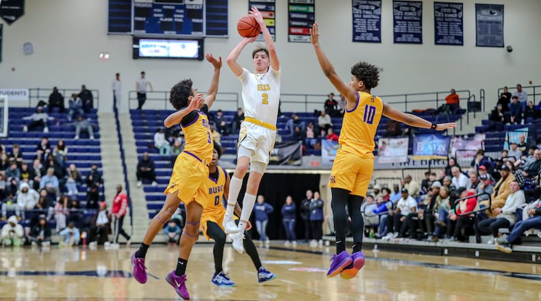 Centerville High School senior Eli Greenberg shoots the ball while being guarded by two Reynoldsburg defenders during their game on Sunday night at The Beacon Orthopaedics Flyin’ to the Hoop Invitational at Trent Arena in Kettering. MICHAEL COOPER/CONTRIBUTED