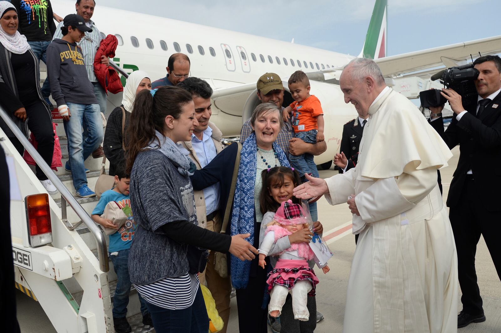 FILE - Pope Francis greets a group of Syrian refugees, arrived with the pontiff's charter plane after the pope's visit to the Greek island of Lesbos, at Rome Ciampino airport, Saturday, April 16, 2016. (Filippo Monteforte/Pool Photo via AP, file)