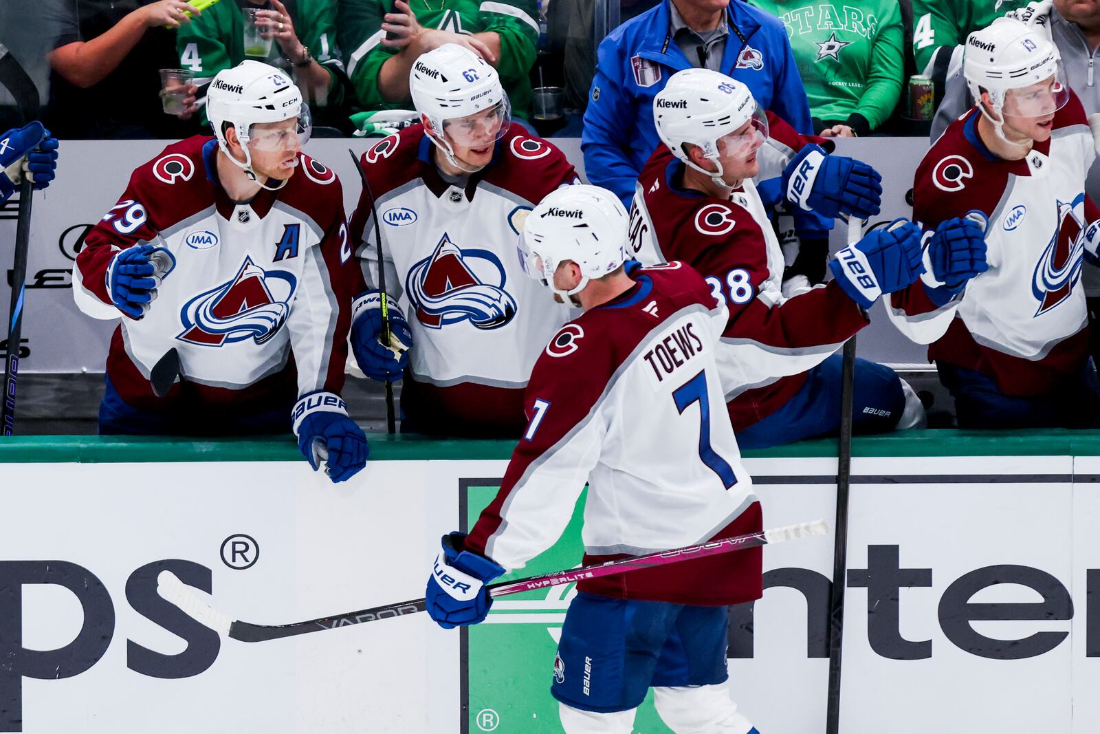 Colorado Avalanche defenseman Devon Toews (7) celebrates with teammates after scoring during a first-round NHL hockey playoff game against the Dallas Stars in Dallas, Saturday, April 19, 2025. (AP Photo/Gareth Patterson)
