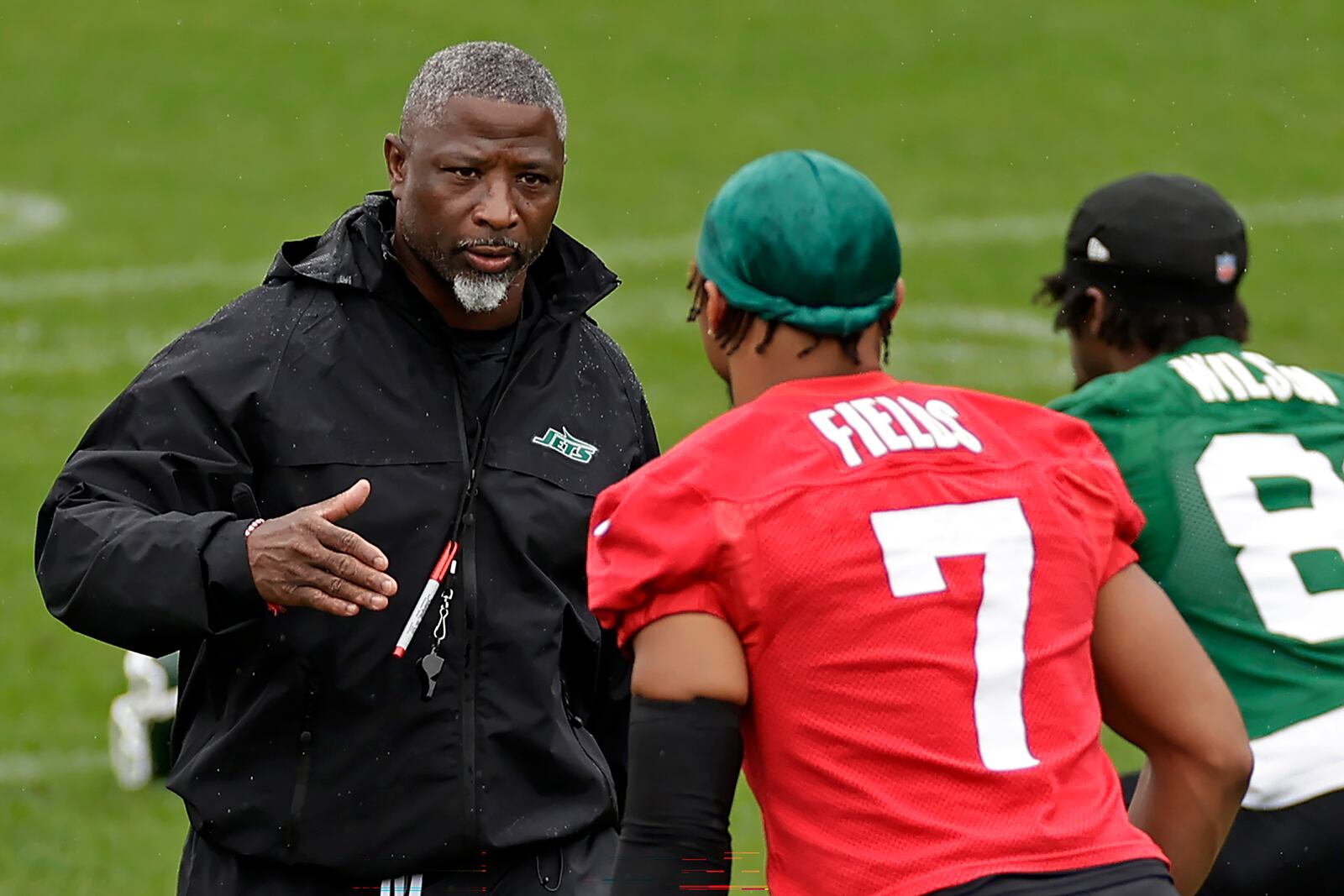 New York Jets head coach Aaron Glenn reaches to shake hands with Justin Fields during practice at NFL football minicamp, Tuesday, June 10, 2025, in Florham Park, N.J. (AP Photo/Adam Hunger)