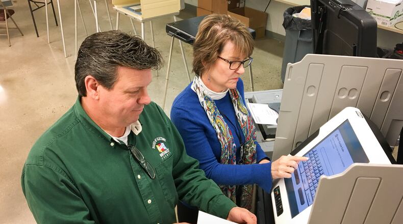 Montgomery County Board of Elections Director Jan Kelly and Deputy Director Steve Harsman give a presentation to county commissioners on the touch-screen hybrid voting system the elections board members recommend. CHRIS STEWART / STAFF