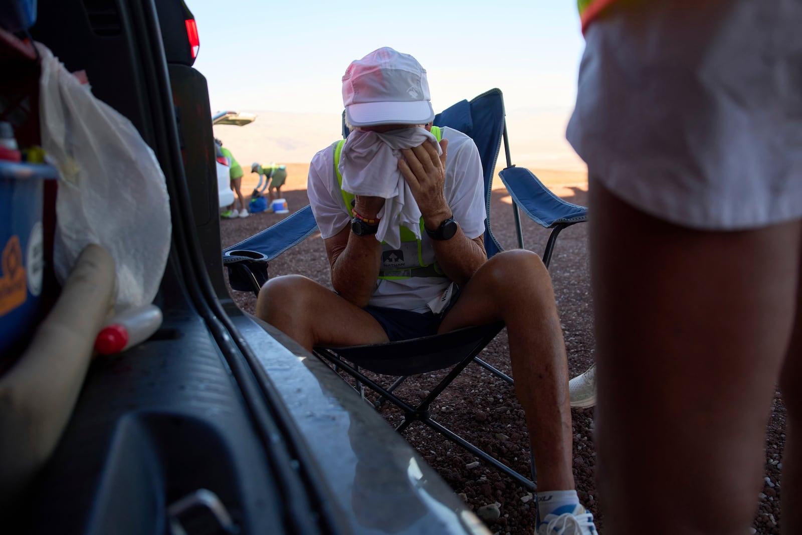 Danny Westergaard cools off in the shade while taking a short break during the Badwater 135 Ultramarathon, Tuesday, July 8, 2025, in Death Valley National Park, Calif. (AP Photo/John Locher)