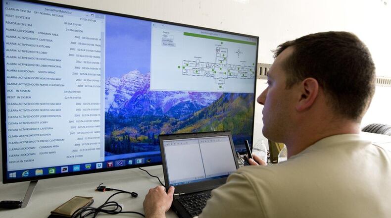 Former U.S. Air Force Capt. Chris Perrine, Air Force Life Cycle Management Center, chief of acquisitions for net centric services-2, from Robins Air Force Base, Ga., monitors his team’s active shooter detection system during the 2015 Air Force Research Laboratory Commander’s Challenge. The system, which was patented by the Air Force, enables dispatchers to see exactly where in the building an alarm was activated and inform emergency responders, allowing them to better respond to the threat. Protective Innovations LLC, a company started by Perrine after his separation, licensed the technology for commercialization in 2017. (U.S. Air Force photo/Wesley Farnsworth)