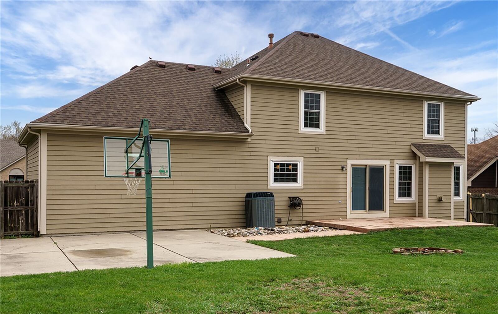 The rear of the home features a paver patio and basketball court.
