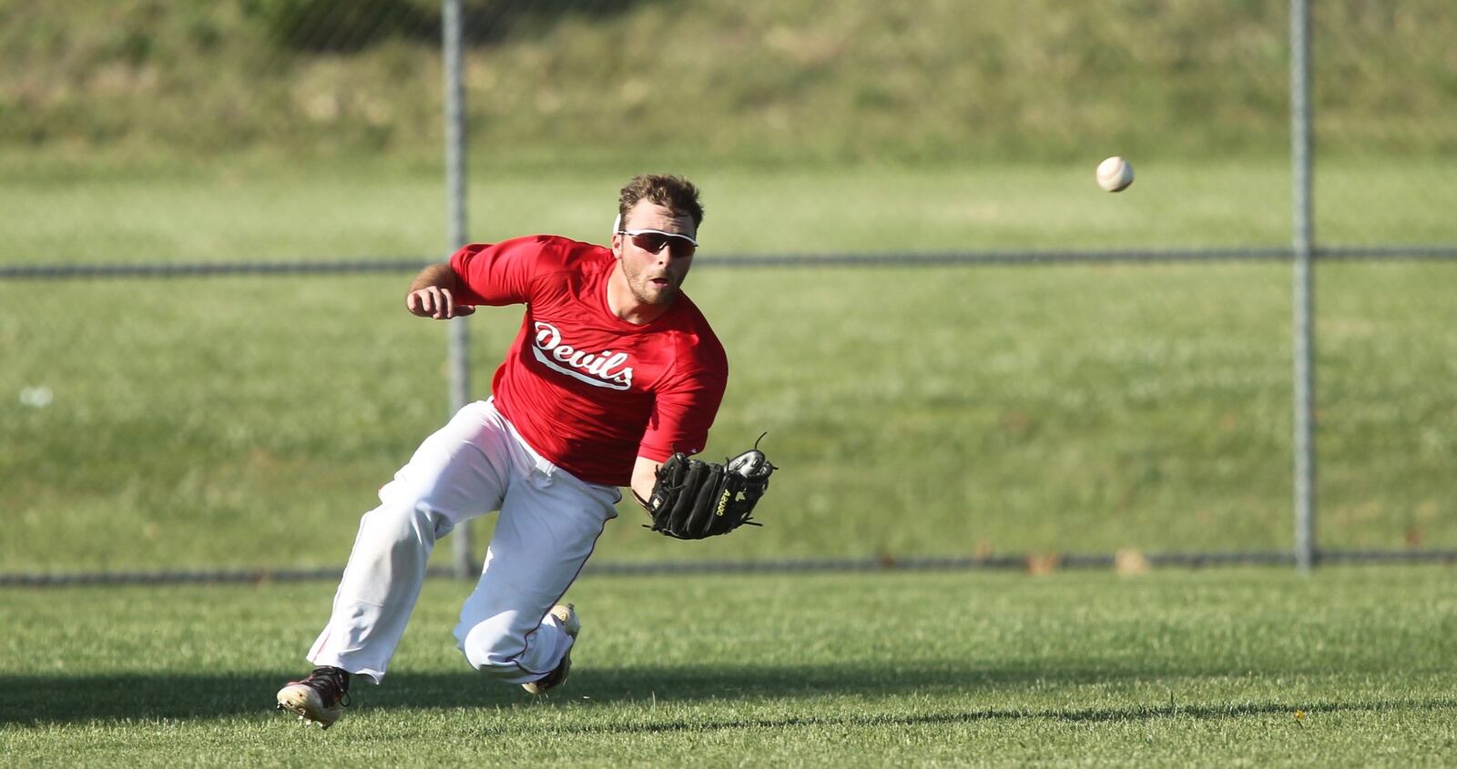 Tippecanoe’s Justyn Eichbaum dives to try to make a catch against Kenton Ridge in a Division II sectional final at Tecumseh High School on Thursday, May 18, 2017. David Jablonski/Staff