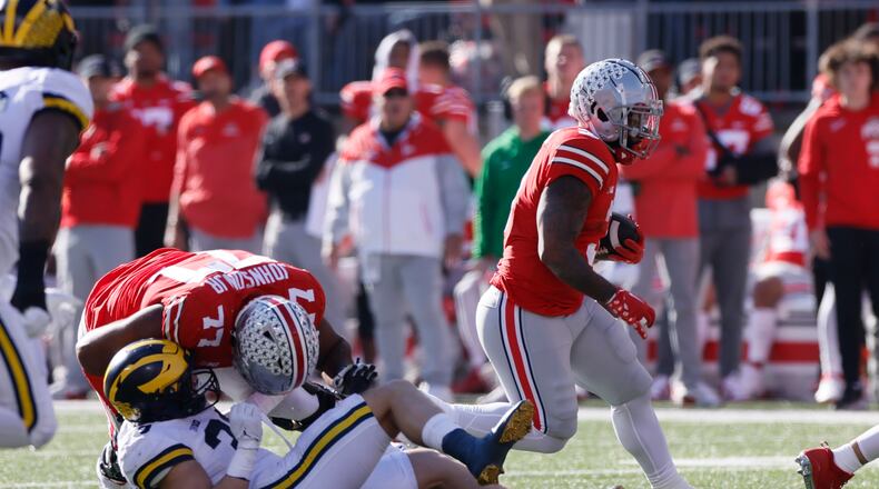 Ohio State running back Miyan Williams, right, follows a block by teammate Paris Johnson against Michigan during the first half of an NCAA college football game on Saturday, Nov. 26, 2022, in Columbus, Ohio. (AP Photo/Jay LaPrete)