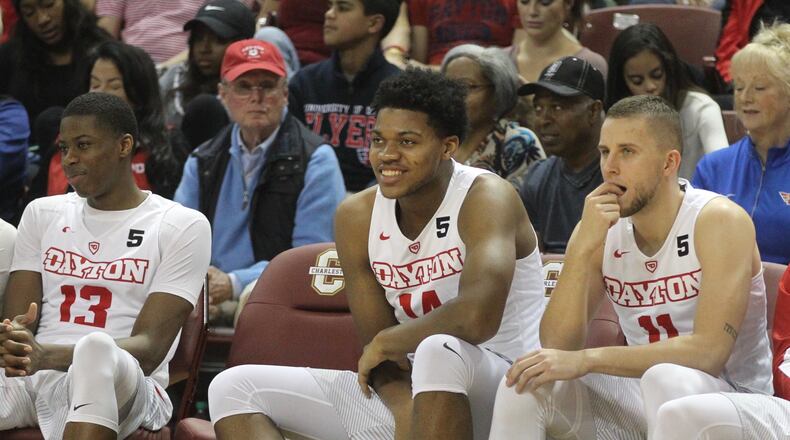 Dayton’s Jordan Pierce smiles on the bench during the second half Friday against Ohio at TD Arena in Charleston, S.C. David Jablonski/Staff