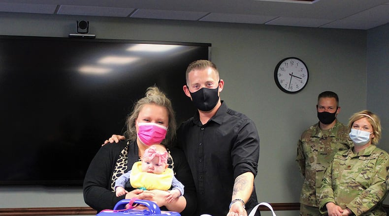 Matt and Lauren McLaughlin, along with their daughter, Maya, make a CuddleCot donation May 10 at Wright-Patterson Medical Center. U.S. AIR FORCE PHOTO/KRISTEN VAN WERT