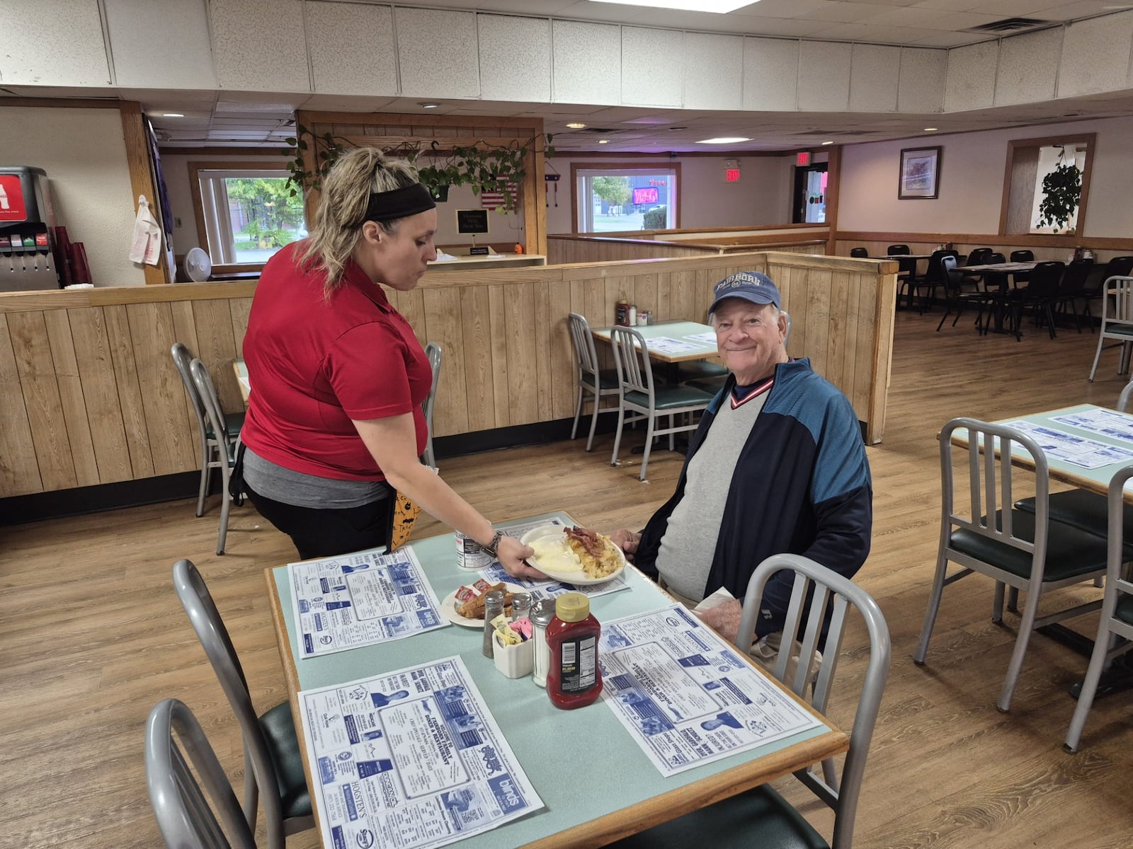 Christina Lauderman serves Jack Norris his breakfast Wednesday at the nearly empty Fairborn Family Diner near Wright Patterson Air Force Base. They said that since the government shutdown, business has taken a noticeable hit. MICHAEL KURTZ / STAFF