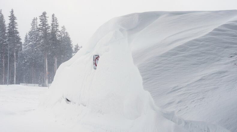 Snow piles up along a road on Wednesday, Feb. 18, 2026 near Soda Springs, Calif. (AP Photo/Brooke Hess-Homeier)