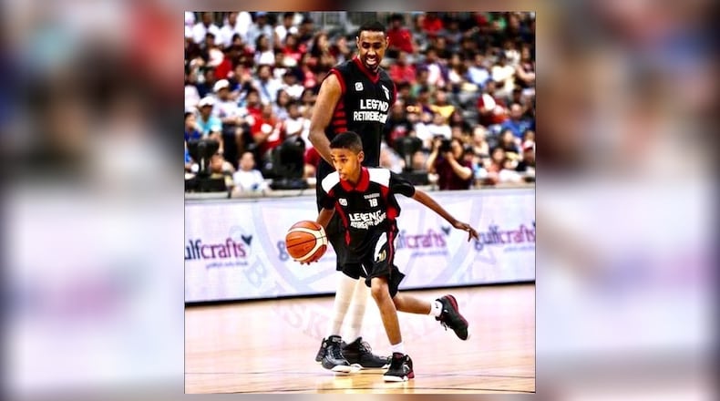 The glorious father-son moment between Yassin Mousa and his 10 year old boy Hamad at the final game of Yassin’s illustrious basketball career. A national sports hero in Qatar, he was honored in 2016 with a “Legends Retirement Game” in front of crowd that continually chanted his name at the packed Ali Bin Hamad al-Attiyah Arena in Doha, Qatar. During the game he his 10-year-old sn Hamad to the court and told the crowd he was passing the torch as he handed a basketball to his son. Hamad dribbled to the end of the court and scored. The boy has gone on to become an internationally-traveled teen hoops star and is now a 6-foot-8 freshman for the Dayton Flyers. CONTRIBUTED