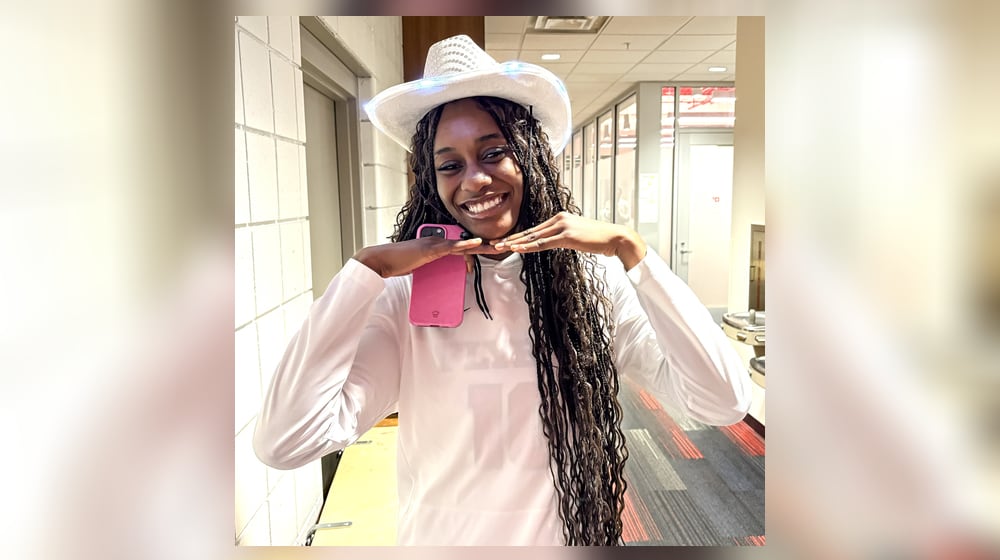 Fatima Ibrahim, who led Dayton with 17 points and 11 rebounds in Sunday’s 72-66 loss to Belmont at UD Arena, wears one of the blinking light cowboy hats given out to the first 200 fans as part of the team’s Country Music Day promotion. Born in Nigeria and raised in Manitoba, Canada, the 6-foot-3 Ibrahim said Sunday was just the second time in her life she ever wore a cowboy hat. She said she liked it. CONTRIBUTED PHOTO