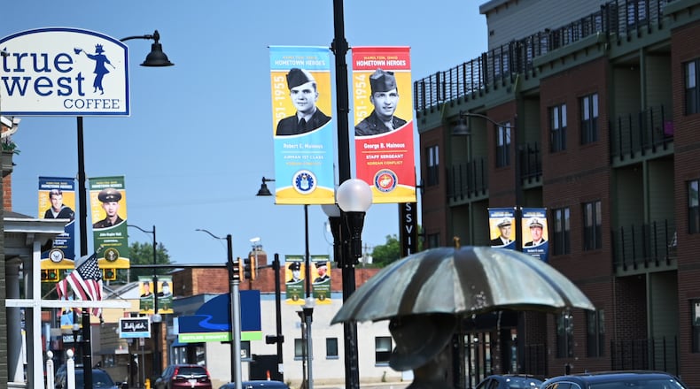 The Hamilton Hometown Heroes banners will annually hang from city posts from Memorial Day through Veterans Day. For 2024, more than 360 banners are displayed throughout Hamilton streets and their locations can be found on the city of Hamilton, the Journal-News, the Greater Hamilton Chamber of Commerce, and the Hamilton Community Foundation websites. Banners represent pictures of current and former Hamilton residents who served or are serving in a branch of the military. MICHAEL D. PITMAN/STAFF