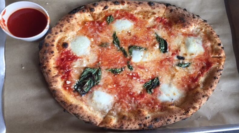 Inizio's version, with a beautifully freckled crust, comes with a little cup of marinara on the side.
(Kathleen Purvis/Charlotte Observer/TNS)