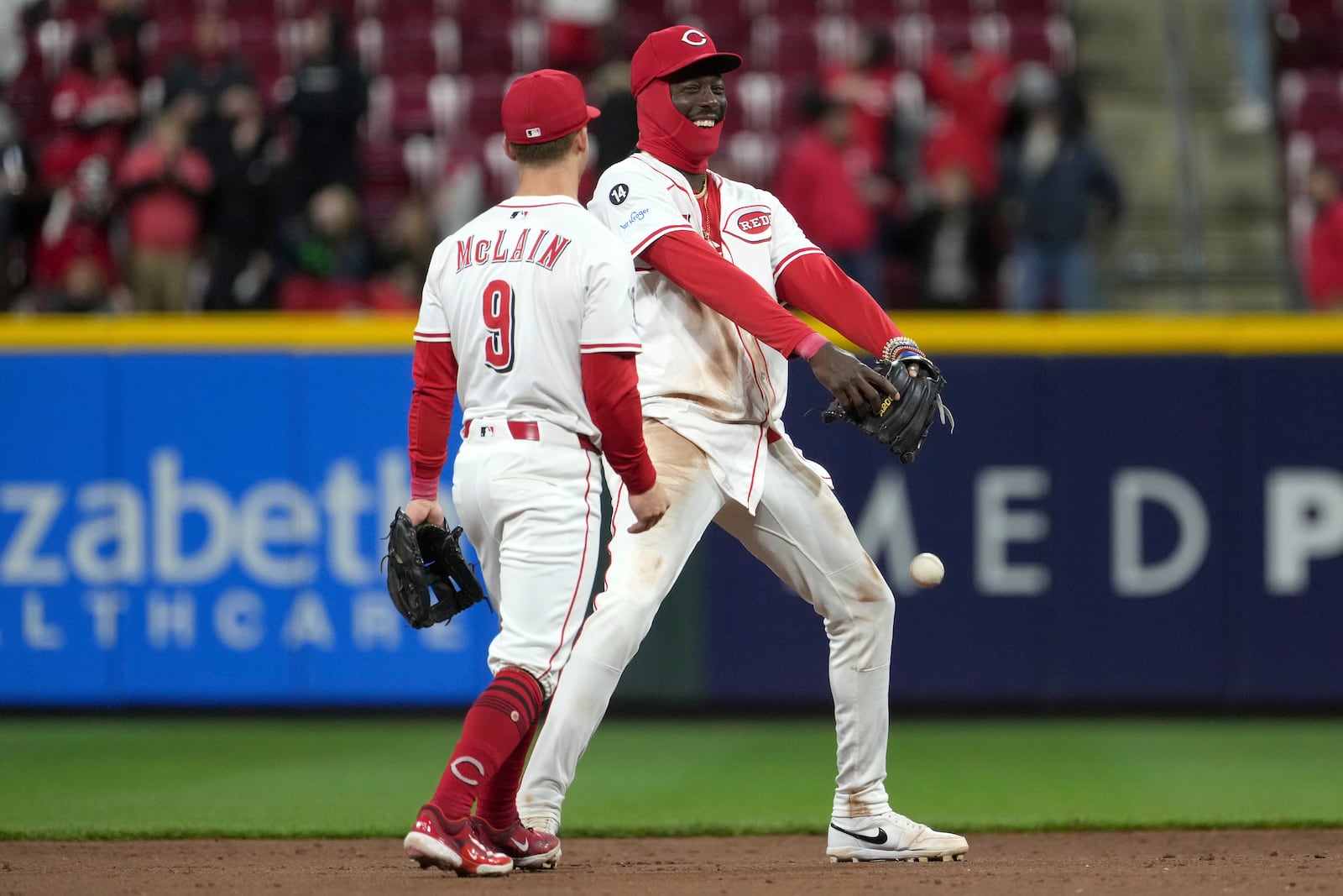 Cincinnati Reds' Matt McLain, left, and Elly De La Cruz, right, celebrate after a win in a baseball game against the Texas Rangers, Monday, March 31, 2025, in Cincinnati. (AP Photo/Kareem Elgazzar)