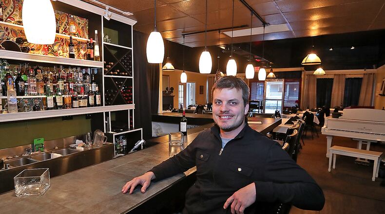 Micah Berner, the owner of Cecil & Lime Cafe at the restaurants new, larger bar. Bill Lackey/Staff