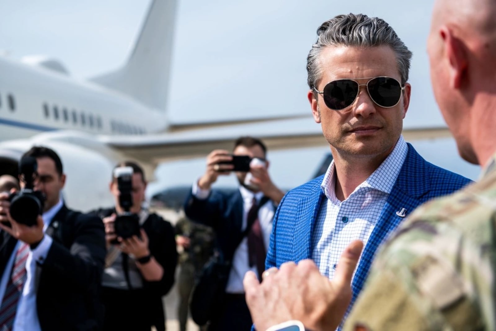 Secretary of Defense Pete Hegseth, left, listens to Air Force Col. Edward Szczepanik, 6th Air Refueling Wing commander, at MacDill Air Force Base, Fla. in May. Air Force photo by Senior Airman Zachary Foster