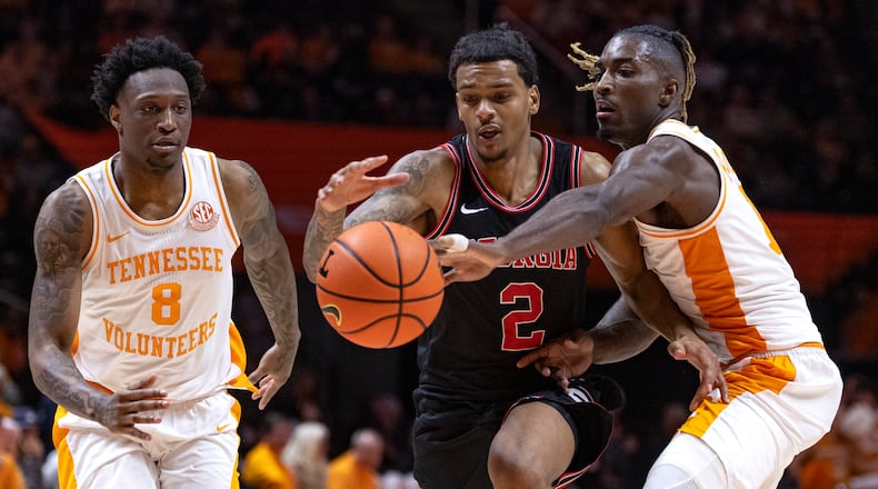 Tennessee guard Jahmai Mashack (15) knocks the ball away as Georgia guard De'Shayne Montgomery (2) tries to drive between him and guard Darlinstone Dubar (8) during the second half of an NCAA college basketball game Wednesday, Jan. 15, 2025, in Knoxville, Tenn. (AP Photo/Wade Payne)