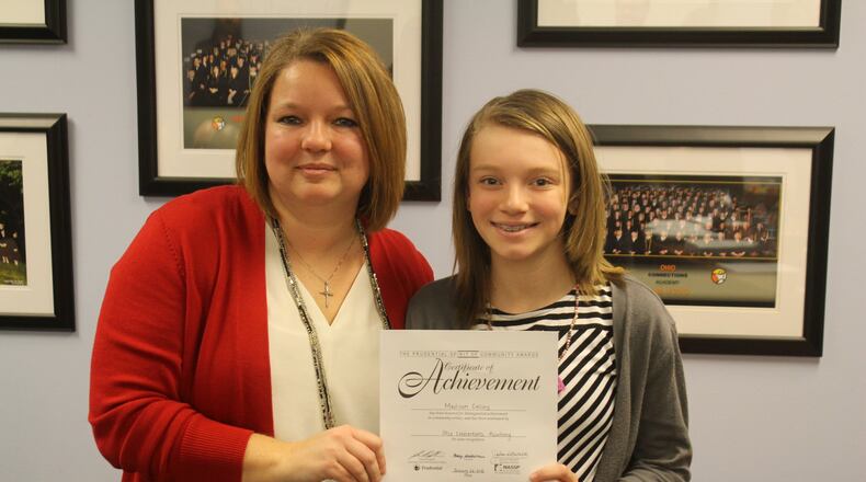 Ohio Connections Academy K-8 Principal Katie Brecheisen presents a 2018 Prudential Spirit of Community Certificate of Achievement to OCA sixth grader Madison Collins, of Hamilton, in recognition of her outstanding volunteer community service. Madison, 12, has volunteered for Greater Hamilton Safety Council’s Safety Town every year since she was 7 years old. CONTRIBUTED