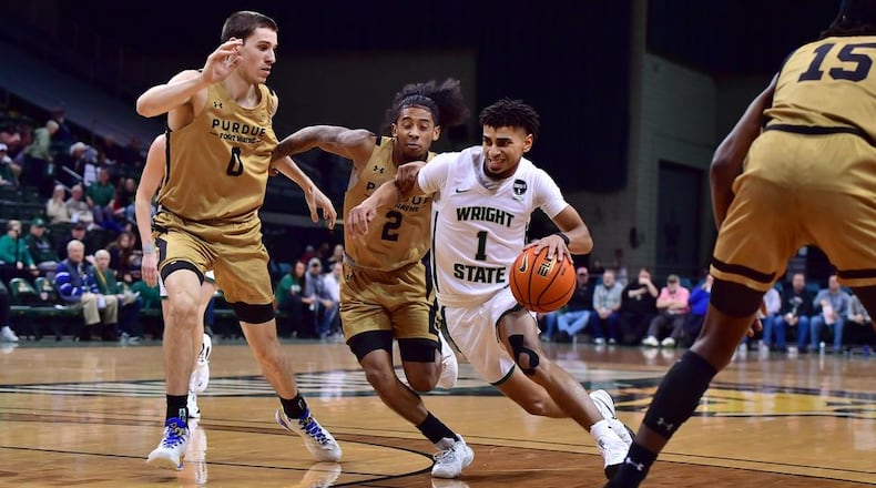 Wright State's Trey Calvin drives past Purdue Fort Wayne's Bobby Planutis (0) and Damian Qui Chong at the Nutter Center on Jan. 19, 2023. Joe Craven/Wright State Athletics
