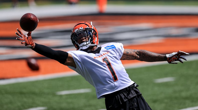 Cincinnati Bengals' Ja'Marr Chase makes a catch as he runs a drill during an NFL football minicamp practice in Cincinnati, Tuesday, June 15, 2021. (AP Photo/Aaron Doster)