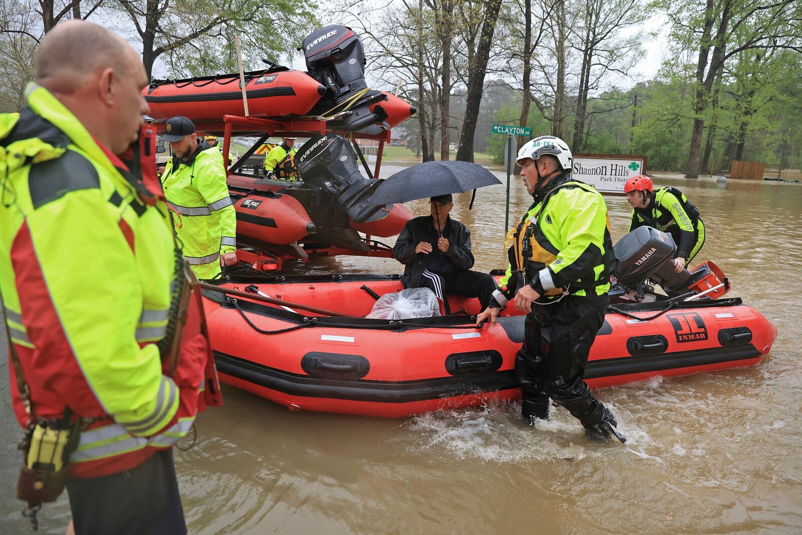 A resident is brought to dry land by boat after being rescued from flood waters by emergency responders from the Benton, Conway and Shannon Hills fire departments and the Pulaski County Emergency Management team in Shannon Hills, Ark., Saturday, April 5, 2025, as a second day of storms brought widespread flooding to the region. (Colin Murphey/Arkansas Democrat-Gazette via AP)
