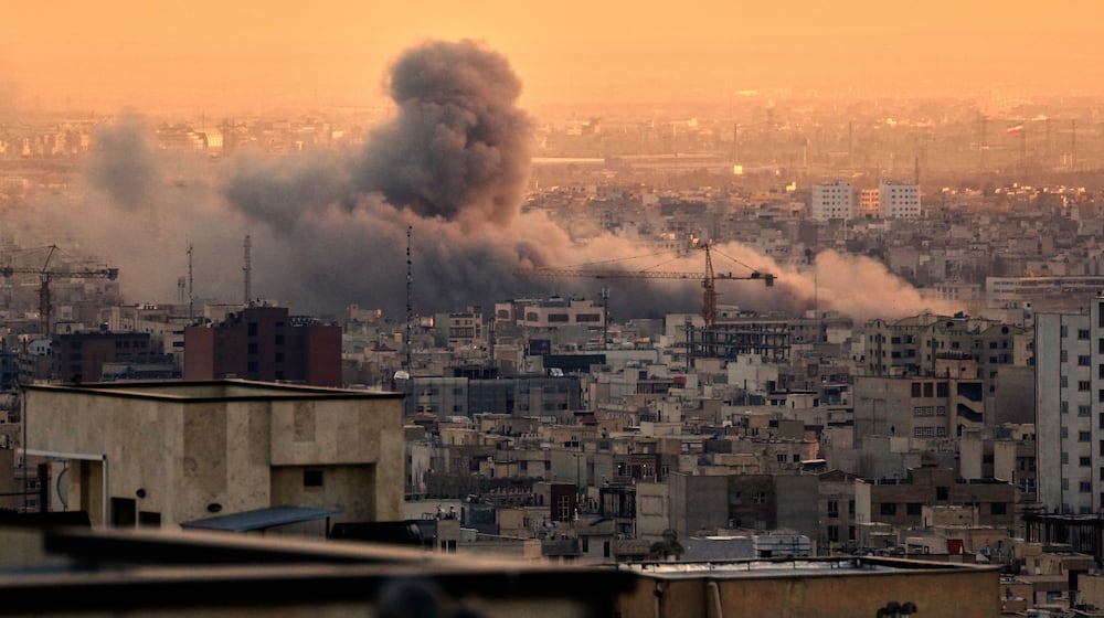 A plume of smoke rises following a U.S.-Israeli military strike in Tehran, Iran, Tuesday, March 3, 2026. (AP Photo/Vahid Salemi)
