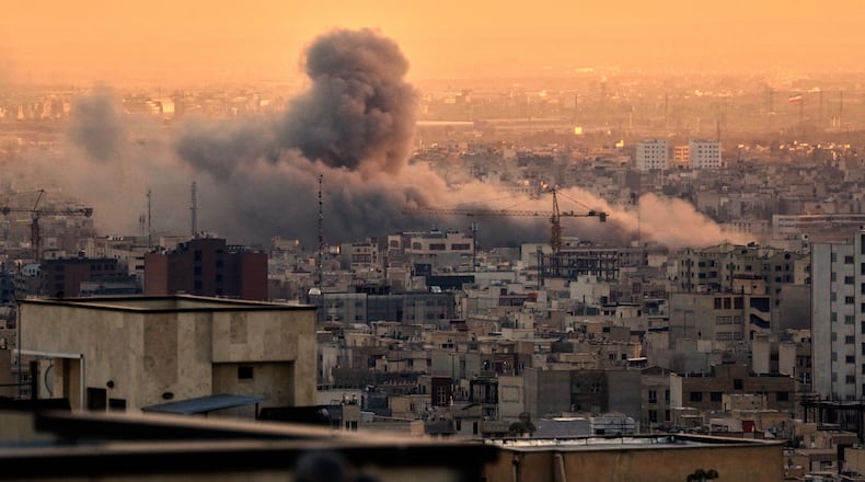 A plume of smoke rises following a U.S.-Israeli military strike in Tehran, Iran, Tuesday, March 3, 2026. (AP Photo/Vahid Salemi)