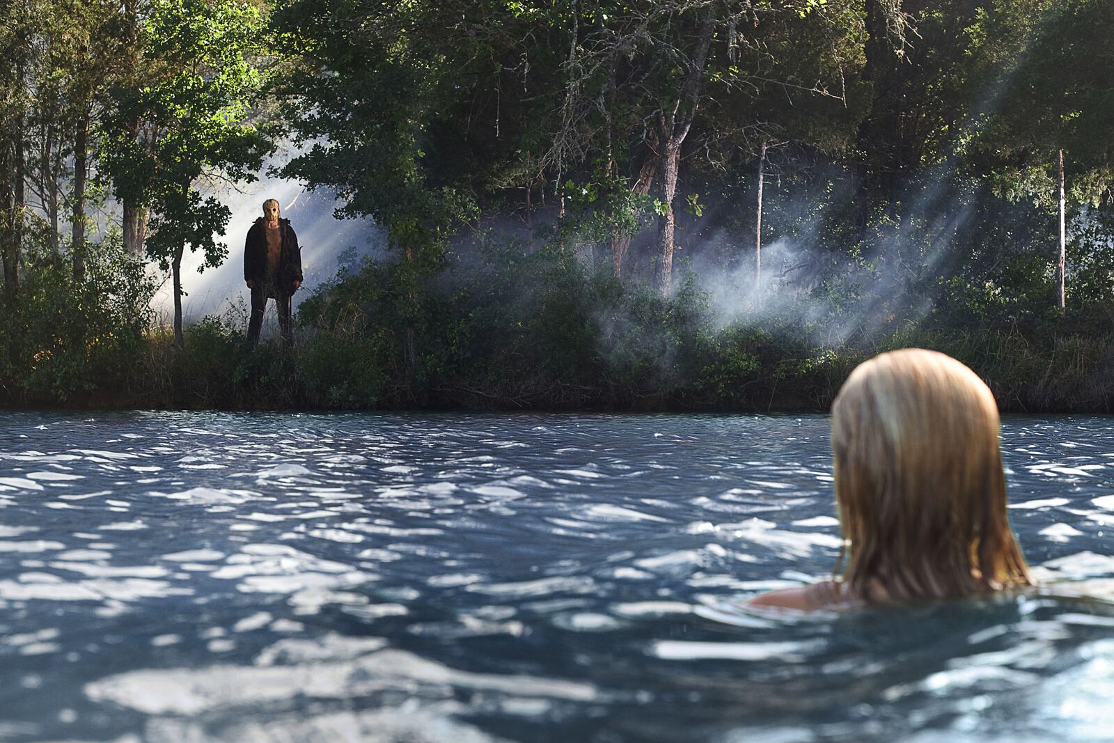 Chelsea (Willa Ford) discovers Jason (Derek Mears) watching her from the shores of Crystal Lake in New Line Cinema's and Paramount Pictures' horror film "Friday the 13th," a Warner Bros. Pictures release.