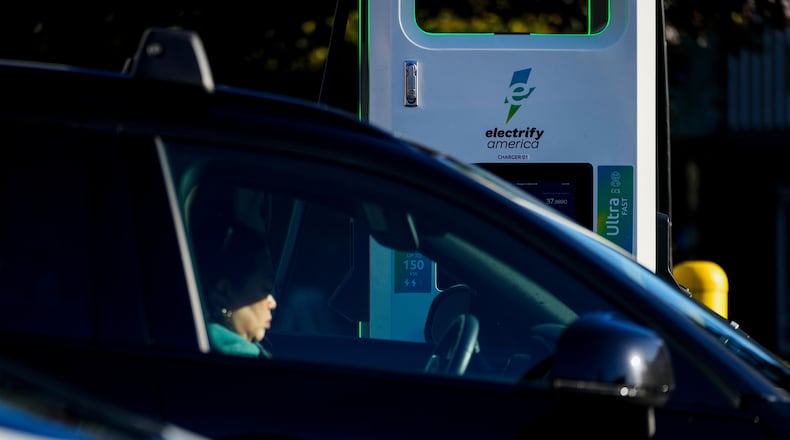 FILE - A driver waits in their car while charging their electric vehicles at an Electrify America station Oct. 9, 2024, in Seattle. (AP Photo/Lindsey Wasson, File)
