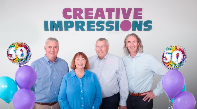 Creative Impressions founders Linda and Denny Carter are flanked by their sons Ed, at left, and Ben Carter. CONTRIBUTED