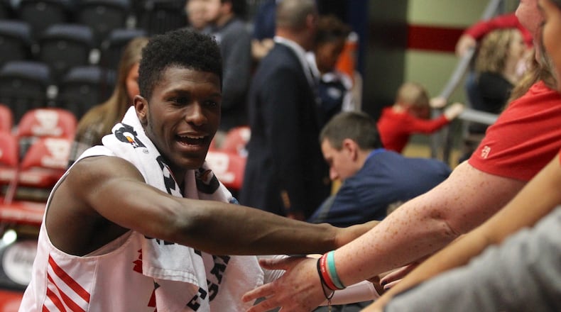 Dayton’s Dwayne Cohill slaps hands with fans in the student section after a victory against Georgia Southern on Dec. 29, 2018, at UD Arena. David Jablonski/Staff