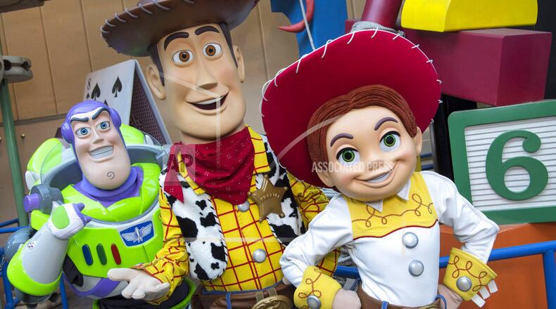 This undated photo provided by Walt Disney World, shows characters from left, Buzz Lightyear, Sheriff Woody and Jessie the Yodeling Cowgirl. The trio will interact with guests in the new Toy Story Land set to open June 30, 2018 at Disney's Hollywood Studios in Lake Buena Vista, Fla. (Divid Roark/Walt Disney World via AP)