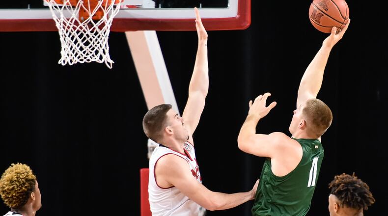 Wright State’s Loudon Love puts up a shot over Miami’s Logan McLane during their game Tuesday, Nov. 14 at Millett Hall on the Miami University Campus in Oxford. The Miami University Redhawks basketball team defeated the Wright State Raiders 73-67 in overtime. NICK GRAHAM/STAFF