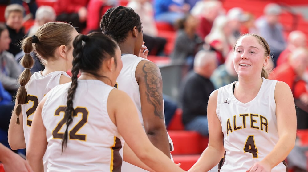 Alter senior guard Alison Link claps hands with teammates after returning to the bench late in a 40-29 win over Cincinnati Indian Hill on Saturday, Feb. 28 at Troy High School's Trojan Activities Center. BRYANT BILLING / STAFF