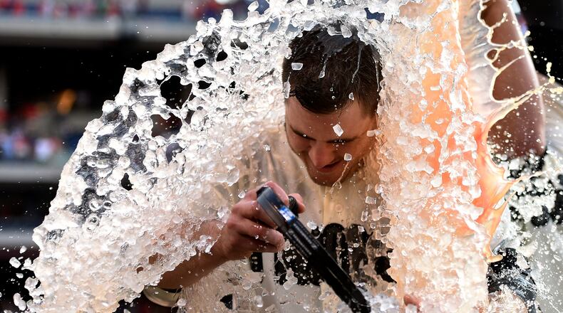 Philadelphia Phillies’ Tommy Joseph is doused by Cameron Rupp at the end of a baseball game against the Cincinnati Reds, Saturday, May 27, 2017, in Philadelphia. (AP Photo/Michael Perez)