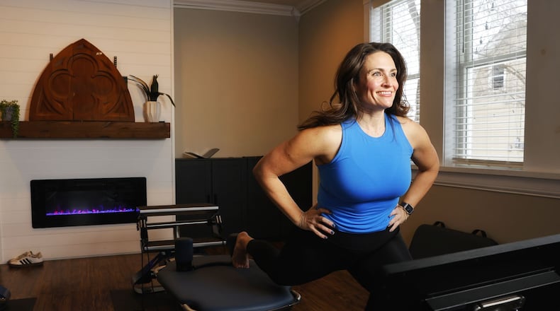 Annie derBoghossian shows the machines she will be using when she opens her new pilates studio, 1111 Pilates, in the Rossville Flats building on Main Street in Hamilton. She plans to be open this spring. NICK GRAHAM/STAFF