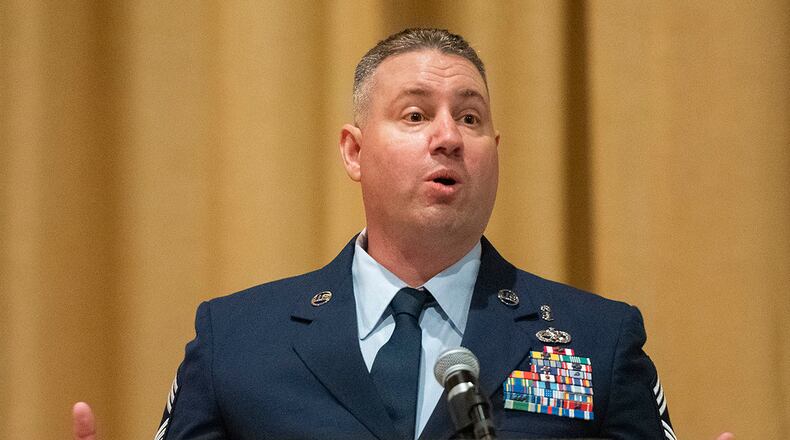 Chief Master Sgt. Erik Robbins, U.S. Air Force School of Aerospace Medicine’s Occupational and Environmental Health Division superintendent, delivers the commencement address during the Community College of the Air Force spring graduation ceremony May 26 in the Wright-Patterson Air Force Base theater. Robbins urged graduates to continue investing in their education. U.S. AIR FORCE PHOTO/R.J. ORIEZ
