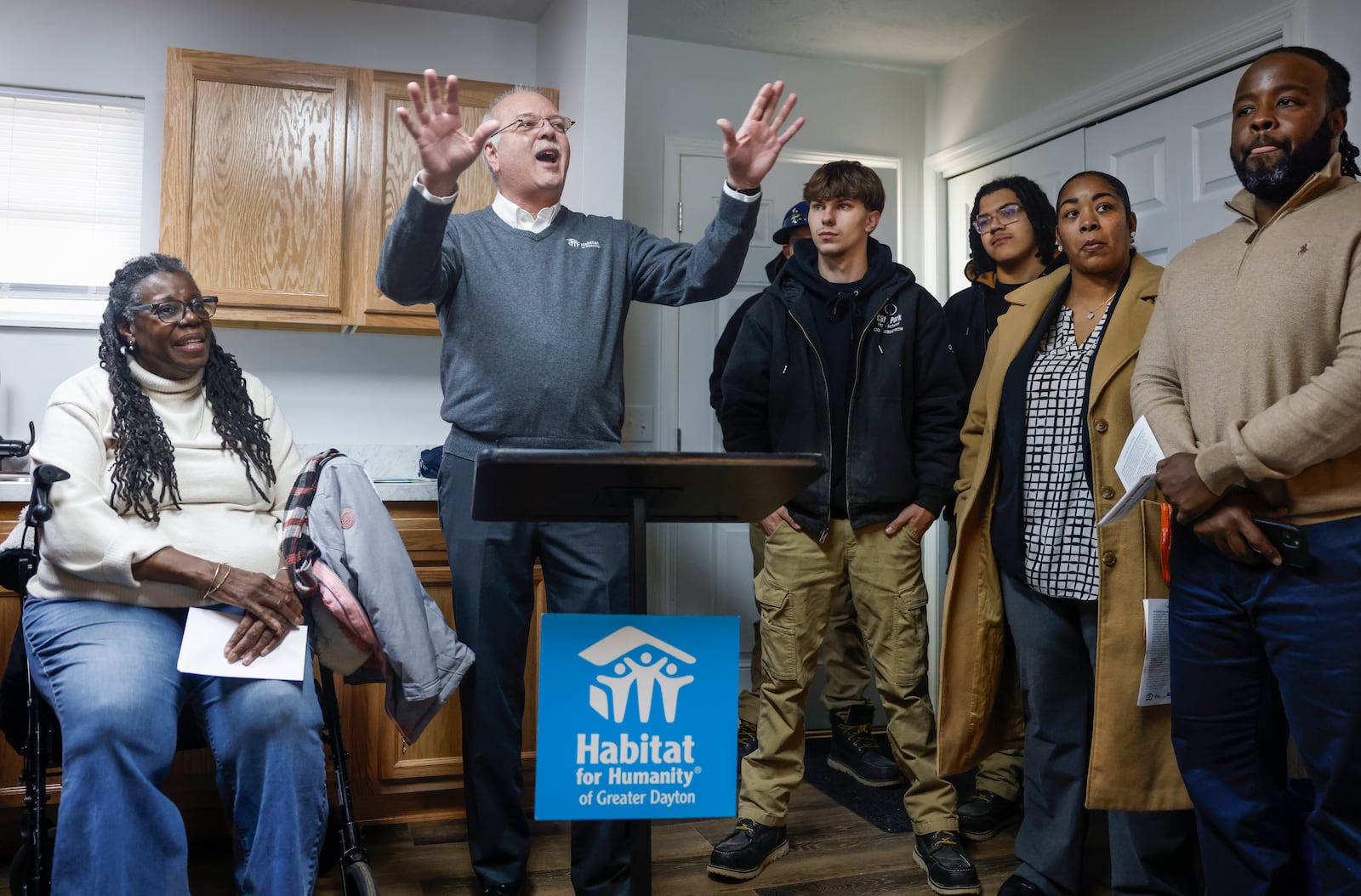 Norm Miozzi, executive director of the Habitat for Humanity of Greater Dayton, speaks to attendees of a home dedication hosted by the Habitat for Humanity of Greater Dayton on Friday, December 12, 2025, in Springfield. The ceremony was for Gwendolyn Iheme, who will live in the house with her 8-year-old granddaughter Rileyanna Foster. JOSEPH COOKE/STAFF