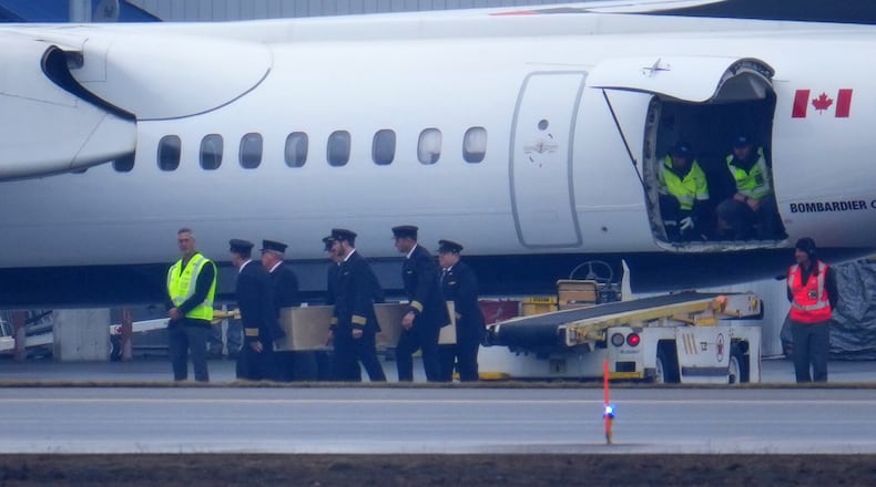 Pilots carry the casket during the repatriation of Jazz Aviation First Officer Mackenzie Gunther, who died after his Air Canada Express plane collided with a fire truck at New York's LaGuardia Airport, in Ottawa, Ontario, Thursday, March 26, 2026. (Sean Kilpatrick/The Canadian Press via AP)