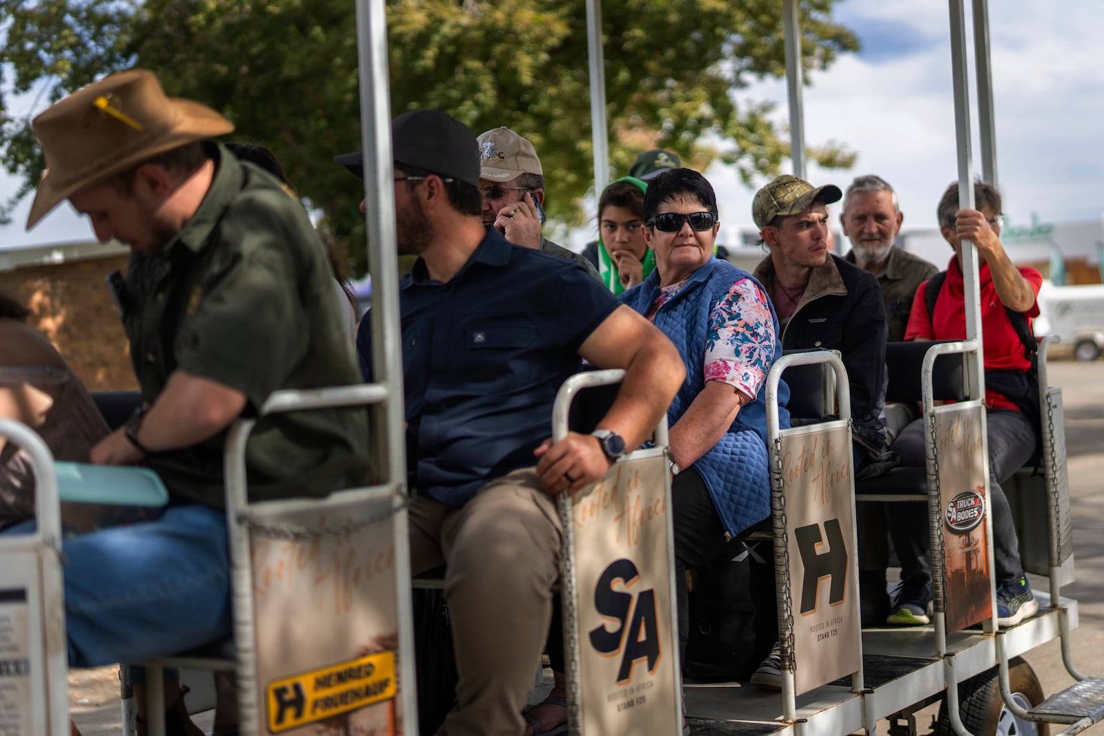 Visitors at the Nampo agricultural fair, one of the largest in the southern hemisphere, ride past the wall of remembrance, a tribute to farmers killed since 1961, near Bothaville, South Africa, May 15, 2025. (AP Photo/Jerome Delay)