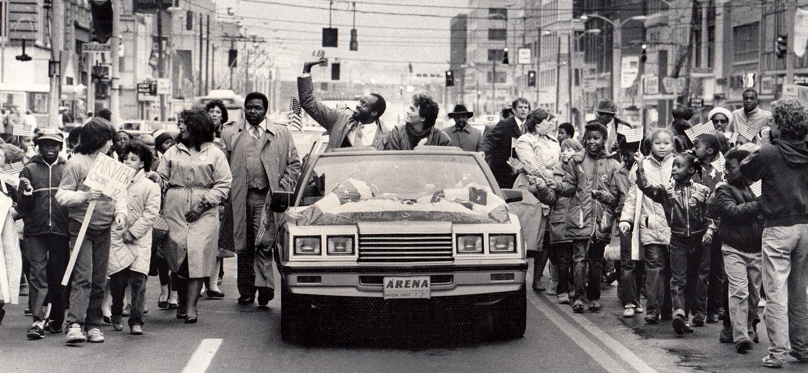 A parade for the two-time Olympic champion was held in downtown Dayton in 1984. Edwin C. Moses and his wife Myrella rode from Courthouse Square to Memorial Hall in a convertible with a patriotic banner covering the hood.More than 1,000 Dayton public school children walked alongside holding American flags high as Moses and his wife waved to the crowd on the streets. DAYTON DAILY NEWS ARCHIVE