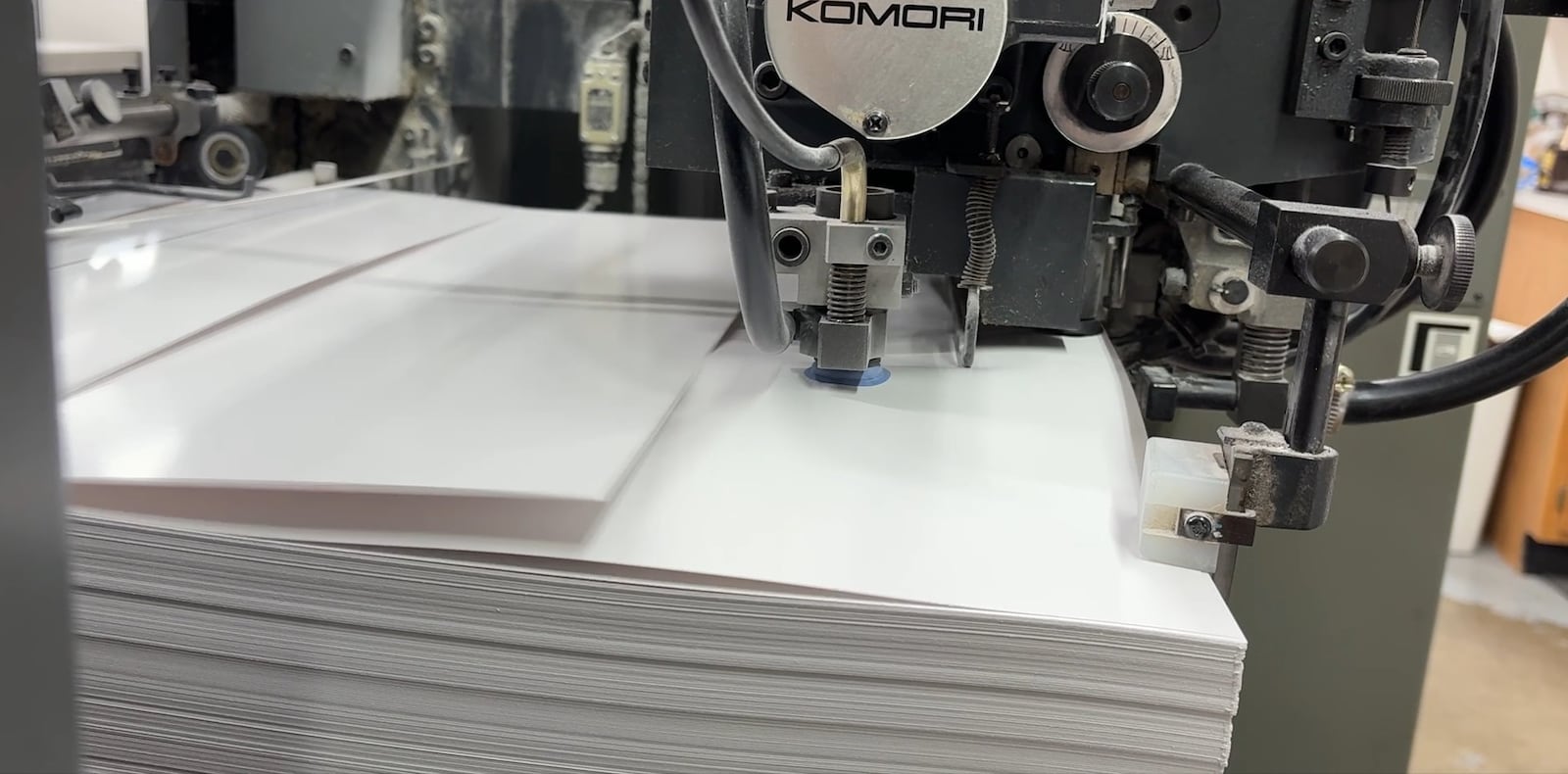 Special paper is fed through a commercial printing machine Friday, Aug. 29, 2025, for a job on behalf of a prescription eyewear company. JEN BALDUF/STAFF