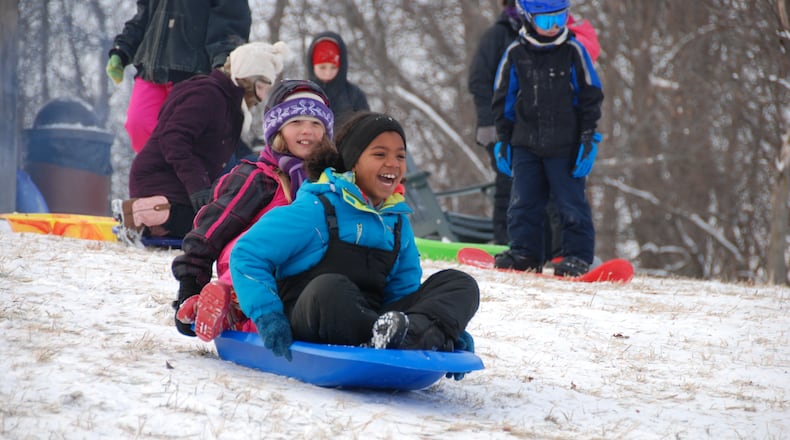 Proper winter wear can make an afternoon of sledding more fun. These young sledders enjoy Taylorsville Metro Park. AMY FORSTHOEFEL/CONTRIBUTED