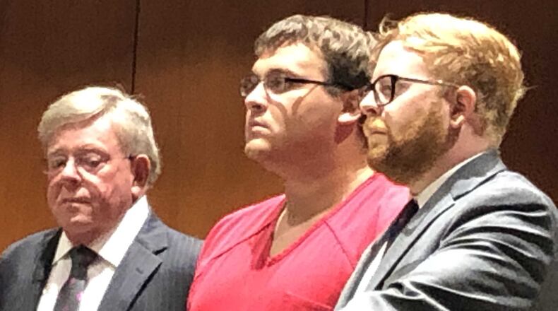 Parents questioned the Springboro school district’s handling of former first-grade gym teacher John Austin Hopkins, 25, of Springboro. He is pictued here during his arraignment, flanked by his father and son defense team, both named David A. Chicarelli.
