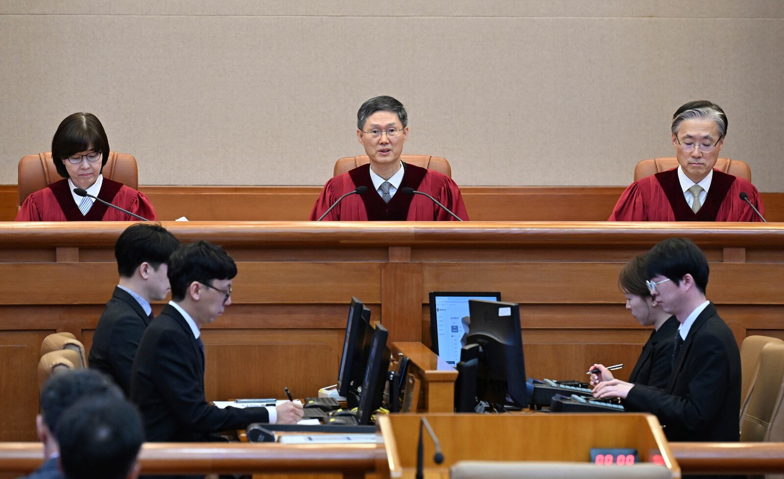 Moon Hyung-bae, center, acting chief justice of South Korea's Constitutional Court, speaks during the final ruling of South Korean President Yoon Suk Yeol's impeachment at the Constitutional Court on Friday, April 4, 2025 in Seoul, South Korea. (Kim Min-Hee, Japan Pool/Kyodo News via AP)