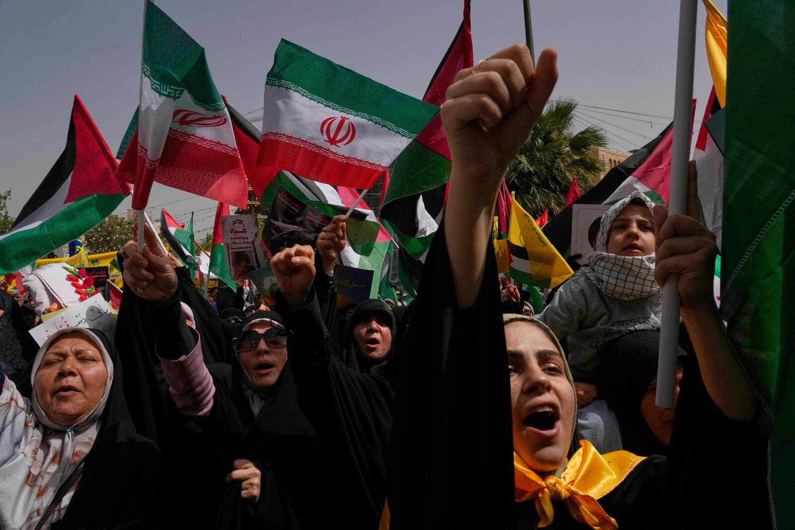 Iranian protesters chant slogans as they wave Palestinian and their country's flags during an anti-Israeli demonstration at the Felestin (Palestine) Sq. in Tehran, Iran, Wednesday, April 9, 2025. (AP Photo/Vahid Salemi)