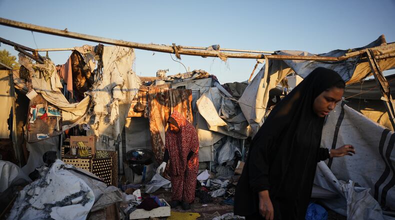 Displaced Palestinians inspect the damage after an Israeli army strike on their tent camp in Deir al-Balah, Gaza Strip, Wednesday, Oct. 29, 2025. (AP Photo/Abdel Kareem Hana)
