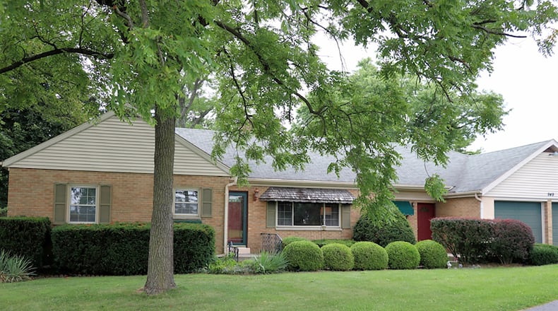 The brick-and-frame home has about 2,245 sq. ft. of living space plus a finished basement. Both the formal entry and the more casual entry are from the front walkway that leads from the driveway with extra parking. There is an attached, 2-car garage. CONTRIBUTED PHOTO BY KATHY TYLER