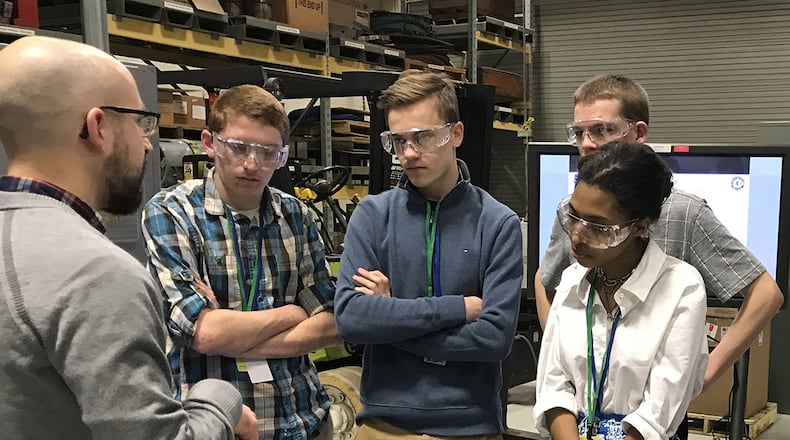 Dr. Eric Payton, materials research engineer, demonstrates the differences between two types of metals to students from local high schools. The students participated in the 2018 Spring Job Shadow Day at Wright-Patterson Air Force Base, where they spent the day learning about mechanical engineering career fields within the Air Force. (U.S. Air Force photo/Staff Sgt. Whitney Trimble)